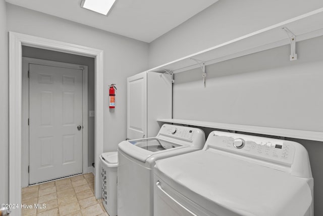 clothes washing area with washing machine and clothes dryer