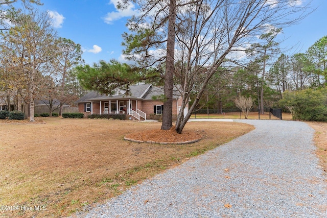 ranch-style house featuring a porch and a front lawn