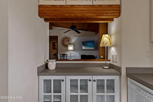 kitchen featuring ceiling fan, dishwasher, wooden ceiling, and beamed ceiling