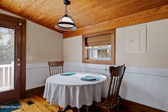 dining area with vaulted ceiling, a wealth of natural light, wooden ceiling, and light hardwood / wood-style flooring