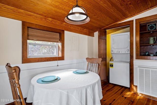 dining area featuring lofted ceiling, stacked washer and dryer, wooden ceiling, and dark hardwood / wood-style floors