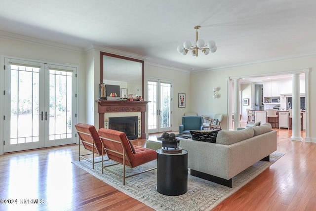 living room with a healthy amount of sunlight, light wood-type flooring, and french doors