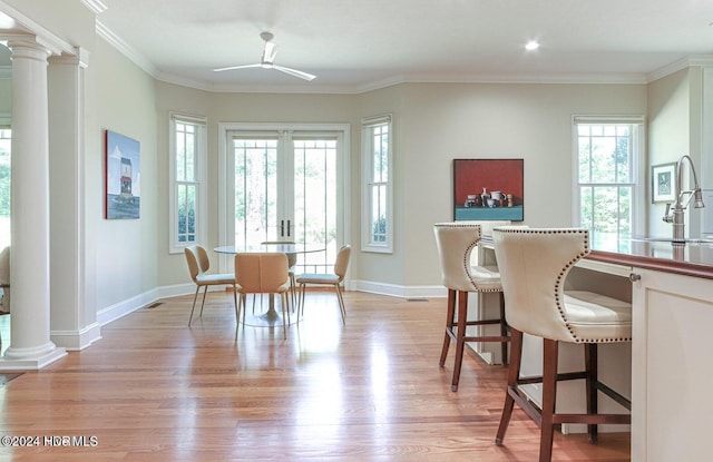 215 Inverrary Rd, Pinehurst, NC 28374 - dining area with healthy amount of natural light, light wood finished floors, decorative columns, ceiling fan, and ornamental molding