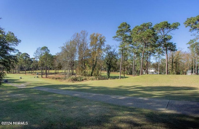 215 Inverrary Rd, Pinehurst, NC 28374 - view of home's community featuring a lawn and view of wooded area