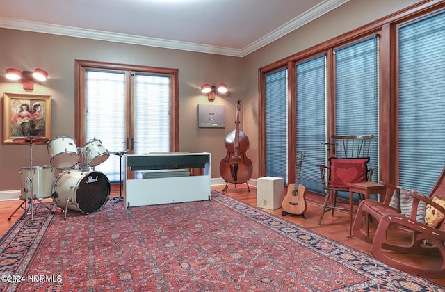 living area featuring ornamental molding and light hardwood / wood-style flooring