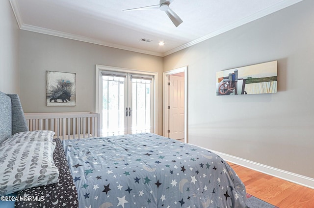 bedroom featuring ceiling fan, wood-type flooring, and ornamental molding