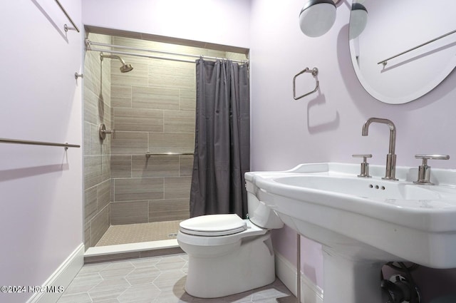 bathroom featuring sink, toilet, and walk in shower