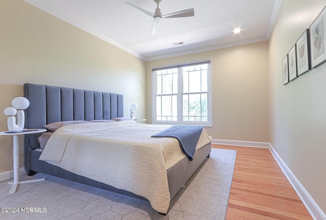 bedroom with ceiling fan, ornamental molding, and hardwood / wood-style flooring