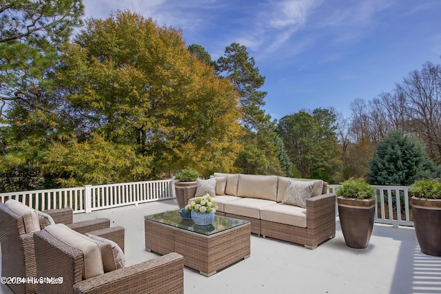 wooden terrace featuring a patio area and an outdoor hangout area