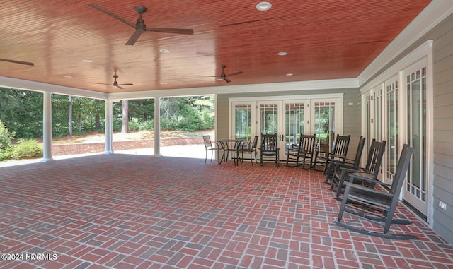 unfurnished sunroom featuring wooden ceiling, a wealth of natural light, and french doors