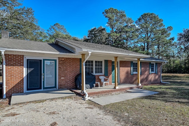 back of property featuring a lawn