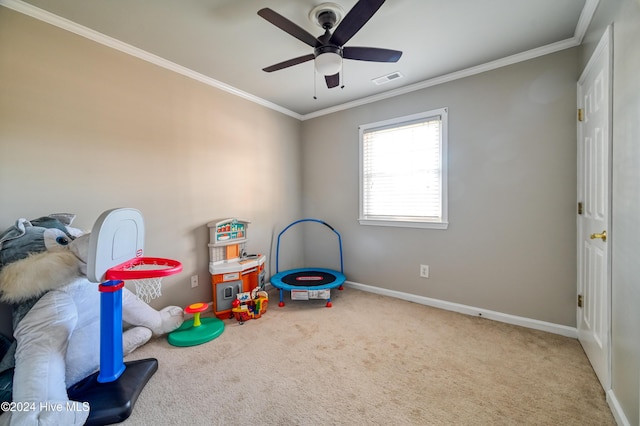 recreation room with crown molding, ceiling fan, and carpet floors