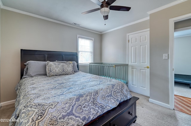 carpeted bedroom with ceiling fan and ornamental molding