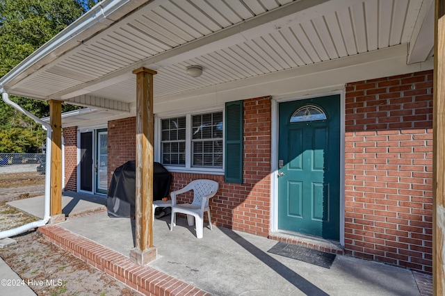 view of exterior entry featuring a porch