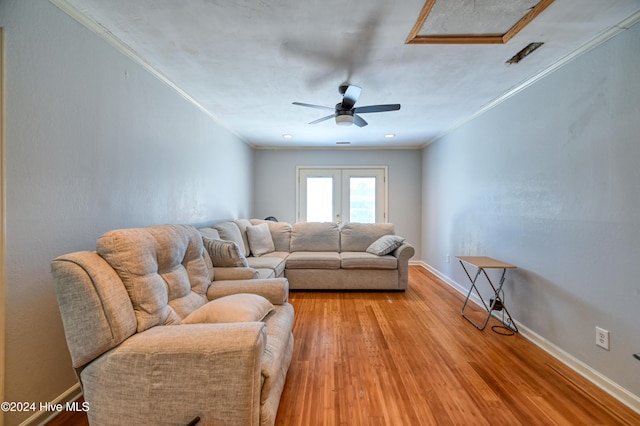 living room with crown molding, light hardwood / wood-style flooring, french doors, and ceiling fan