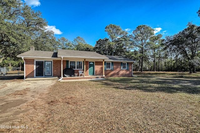 ranch-style home with a patio and a front yard