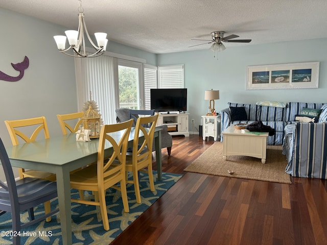 dining room with ceiling fan with notable chandelier, a textured ceiling, and dark hardwood / wood-style flooring