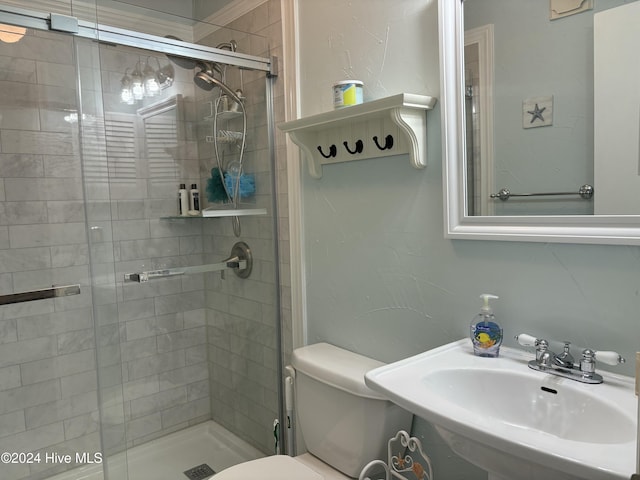 bathroom with toilet, sink, and walk in shower