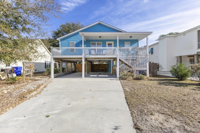 beach home featuring a carport and covered porch