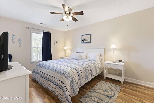 bedroom with ceiling fan and wood-type flooring