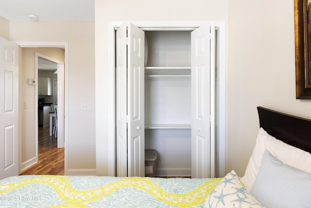 bedroom featuring hardwood / wood-style flooring and a closet