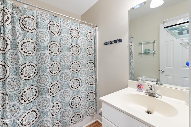 bathroom with vanity, a shower with shower curtain, and toilet