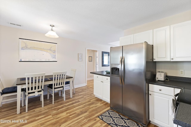 kitchen featuring white cabinetry, stainless steel fridge with ice dispenser, light hardwood / wood-style flooring, pendant lighting, and a textured ceiling