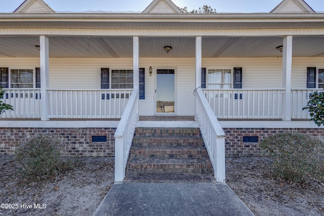 doorway to property featuring covered porch