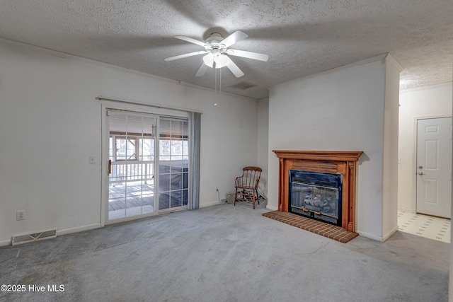 unfurnished living room featuring carpet flooring, ceiling fan, and a textured ceiling