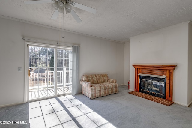 unfurnished living room with a textured ceiling, ceiling fan, a fireplace, and light carpet