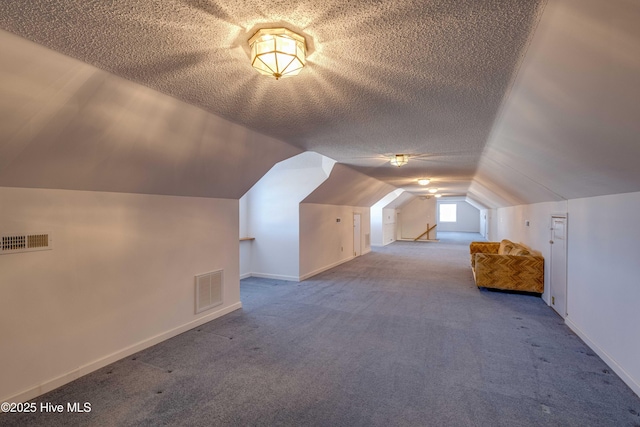 bonus room with carpet flooring, a textured ceiling, and vaulted ceiling