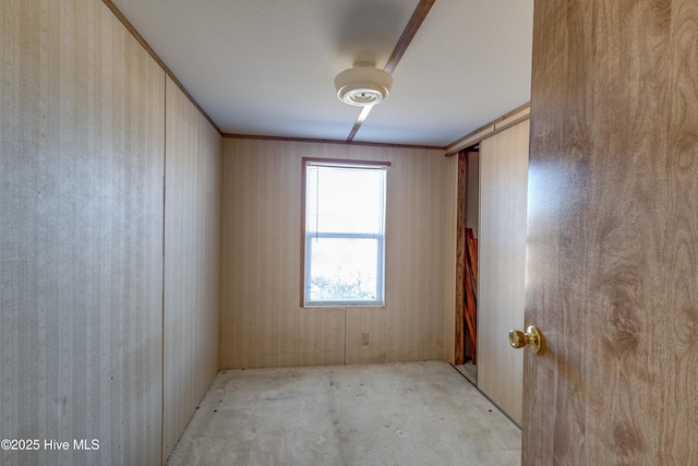 unfurnished room with wood walls