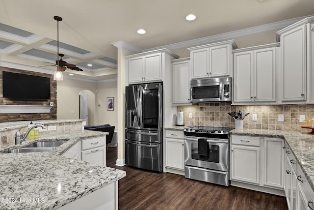 kitchen featuring beamed ceiling, coffered ceiling, white cabinetry, sink, and stainless steel appliances