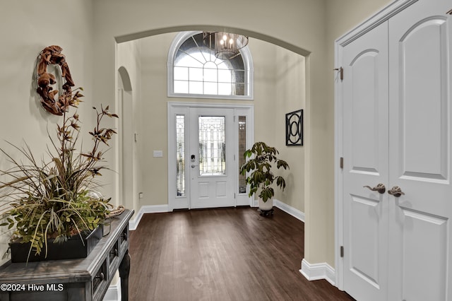 entryway featuring an inviting chandelier and dark hardwood / wood-style floors