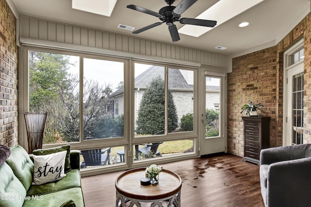 sunroom with ceiling fan and a skylight