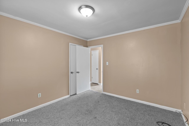 spare room featuring light colored carpet and ornamental molding