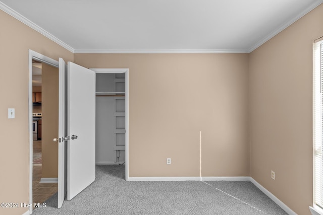 unfurnished bedroom with light colored carpet, a closet, and crown molding