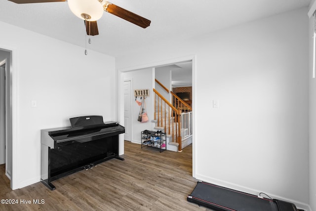 misc room with dark hardwood / wood-style flooring and ceiling fan