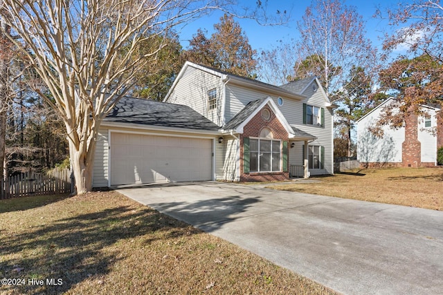 view of front property featuring a garage and a front yard