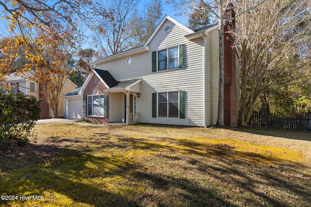 view of front property featuring a garage and a front yard