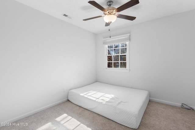 unfurnished bedroom with ceiling fan and light carpet