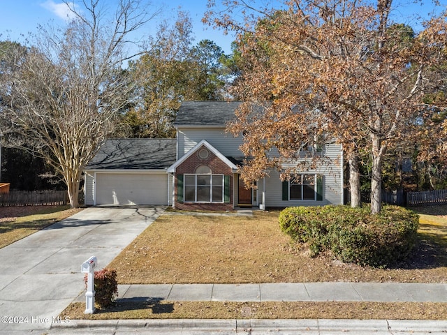 view of front of house with a front yard and a garage