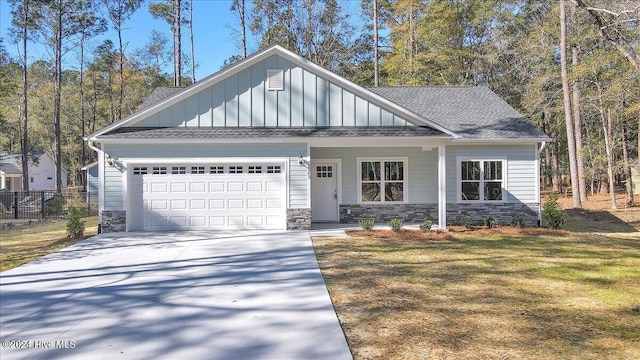 craftsman-style home with a garage and a front lawn