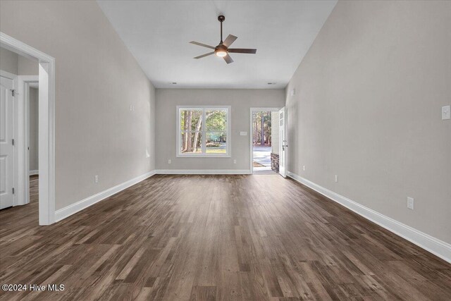 unfurnished living room featuring dark hardwood / wood-style floors and ceiling fan