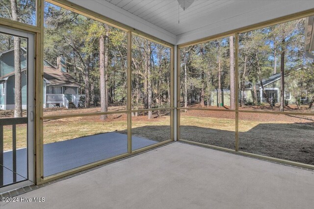 unfurnished sunroom featuring wood ceiling