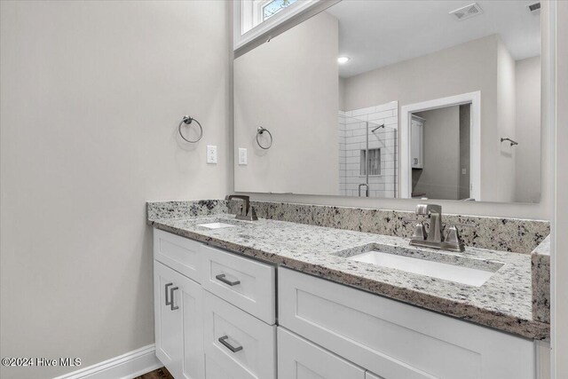 bathroom featuring vanity and an enclosed shower