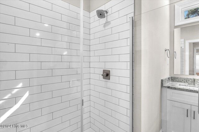 bathroom with vanity and a shower with shower door