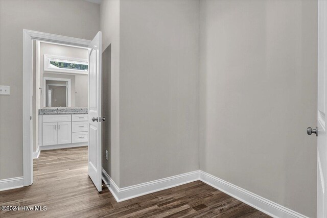 hallway featuring hardwood / wood-style floors and sink