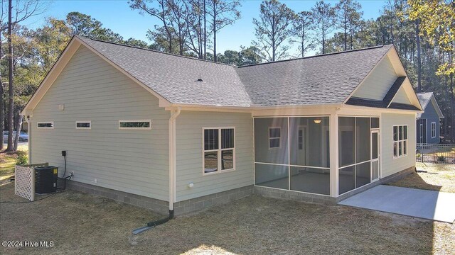 back of house with central air condition unit