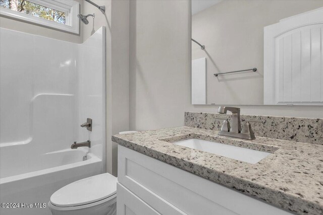 full bathroom featuring vanity, toilet, and washtub / shower combination